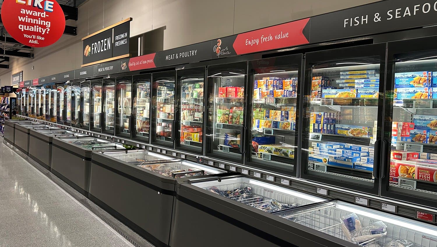 Refrigerated shelves and chest freezers in the aisle of a discount store, supplied via modular switchgear