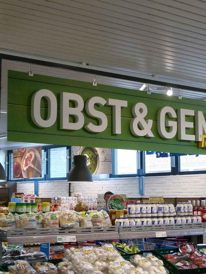 Fruit and vegetable department with refrigerated cabinets in a store