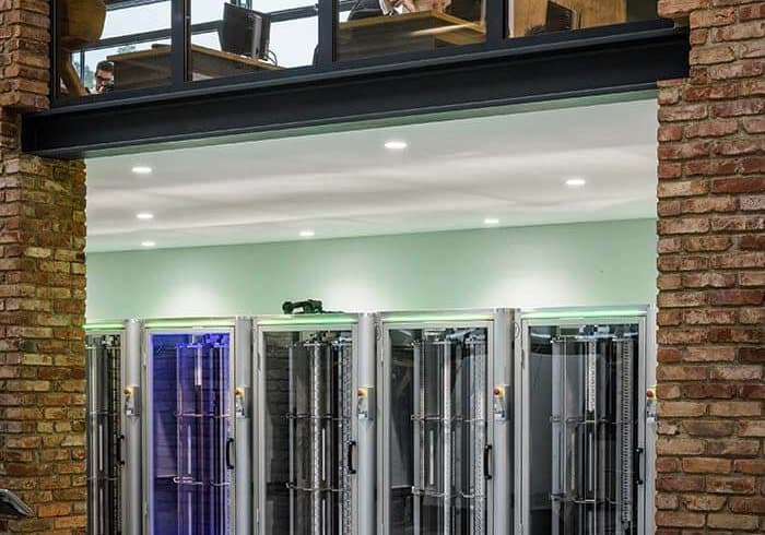 Row of cabinets behind the glass front: power supply for data centres